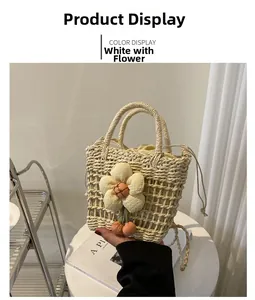 Detail of white handmade straw bucket bag featuring knit flower and cherry charm