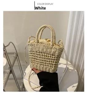 Close-up of cream white woven bucket bag with mesh pattern and drawstring inner pouch
