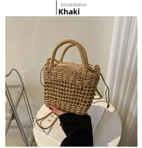 Detail of khaki straw woven bucket bag with drawstring liner and dual circular handles