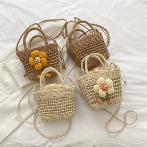 Mini handwoven straw beach bags with floral accents and drawstring closure for women