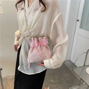 Pink pleated bucket bag with large organza bow and elegant white pearl chain strap