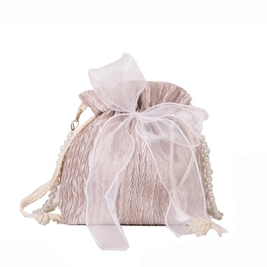 Champagne pink drawstring bucket bag with lace bow and pearl chain strap