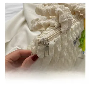Detail shot of smooth metal zipper and beige bubble texture fabric on a stylish handbag