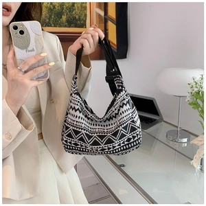 Detail of geometric pattern canvas bag with adjustable strap in modern home office setting