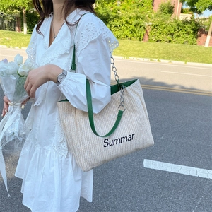 Large straw woven tote bag with green leather straps and Summar embroidery lettering
