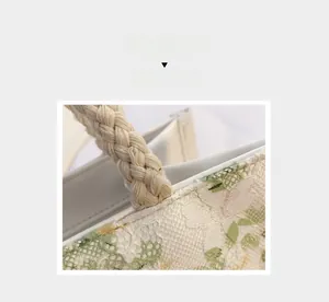 Close-up of thick cotton rope handle and delicate floral lace embroidery on canvas bag