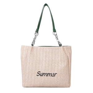 Large straw tote bag with green leather handles and embroidered Summar text on white background