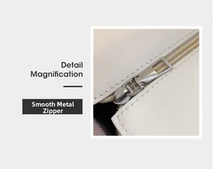 Detail magnification of smooth silver metal zipper on white leather tote bag