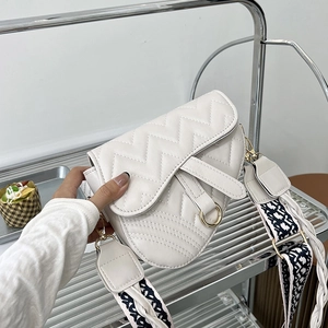 White zigzag quilted saddle bag with golden ring buckle and woven crossbody strap