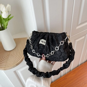 Chic black pleated cloud bag with silver flower chain and scrunchie shoulder strap
