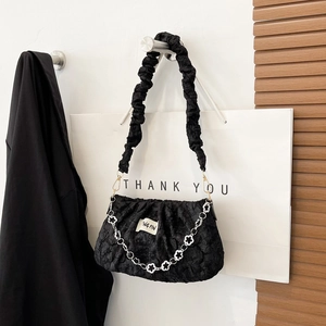 Chic black pleated cloud bag with silver flower chain strap and branded label detail