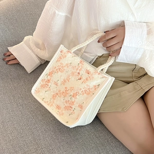 Chic floral lace canvas tote bag with woven handles and white leather trim accents