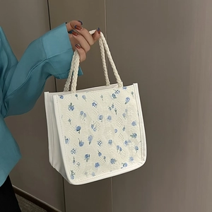 Chic canvas tote bag with blue floral print and white lace overlay for daily use