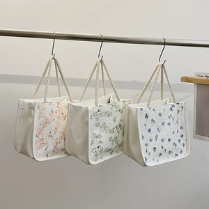 Floral canvas tote bags in pink, green, and blue with braided handles and lace details