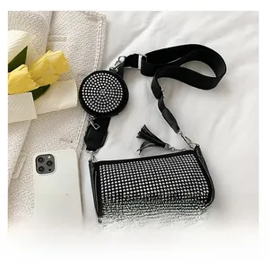 Close-up of black rhinestone shoulder bag with wide strap and matching round coin purse