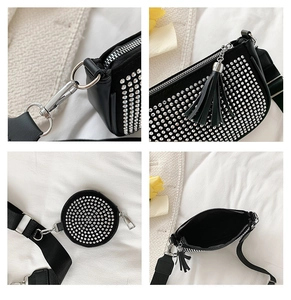 Detail of black faux leather bag featuring silver studs, fringe tassel and mini pouch