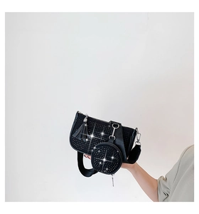 Close-up of black rhinestone 3-in-1 underarm bag with round coin purse and fringe charm