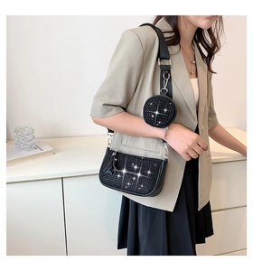 Detail of black rhinestone shoulder bag with wide strap and detachable round pouch
