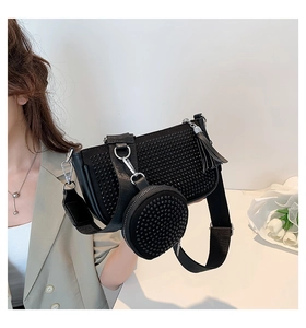 Detail of black rhinestone baguette bag with detachable round coin purse and fringe charm