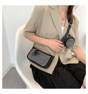 Detail of a black rhinestone hobo bag with detachable coin purse and tassel