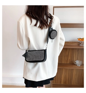Detail of black leather rhinestone bag with side fringe and small round pouch attachment