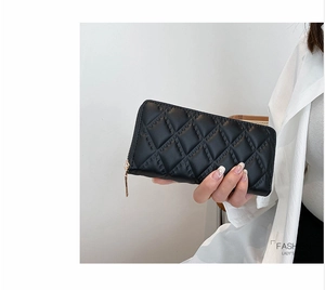 Dettaglio pochette trapuntata in pelle PU nera con zip dorata e scritta fashion