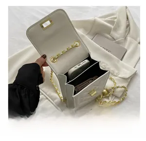 Internal view of a white quilted crossbody bag showing capacity for a phone and cards