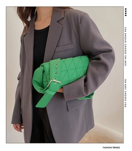 Fashionable bright green quilted crossbody bag with stylish metal buckle on shoulder strap