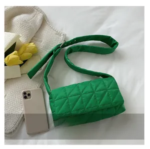 Detailed top view of bright green quilted cotton shoulder bag with adjustable strap