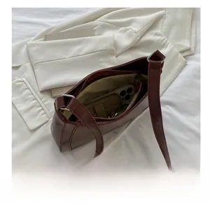 Spacious interior of vintage burgundy underarm bag showing large storage capacity