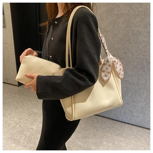 Beige PU leather tote bag set with polka dot silk scarf detail shown on shoulder