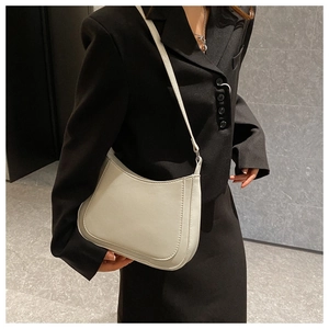 Close-up of minimalist cream white shoulder bag featuring premium texture and sleek lines