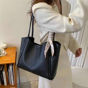 Large black pebbled PU leather tote bag with pink polka dot scarf on a female model