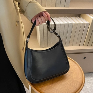 Minimalist black matte faux leather crescent underarm bag with adjustable silver strap buckle