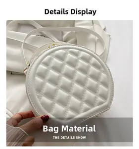 Detail view of white quilted faux leather texture with elegant golden zipper hardware