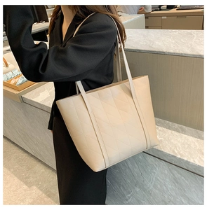 Detailed view of beige quilted tote bag in premium PU leather with elegant diamond pattern