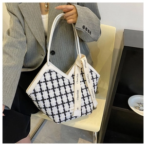 Detailed view of checkered tote bag with V-cut opening and decorative ribbon
