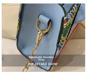 Detail showing detachable golden chain strap and colorful woven side on light blue bag