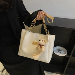 Creamy white leather tote bag with fashion tag, gold chain and cute bear charm