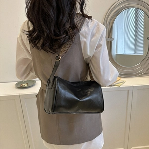 Minimalist black Boston pillow bag with wide geometric pattern jacquard strap for women