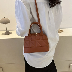 Brown shell-shaped crossbody bag with triangle quilted patterns and top handle