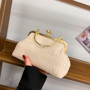 Chic beige woven straw clutch bag with gold round metal handle and floral embossed frame