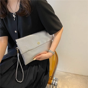 Silver pebble leather envelope clutch bag with golden clover logo and wrist strap