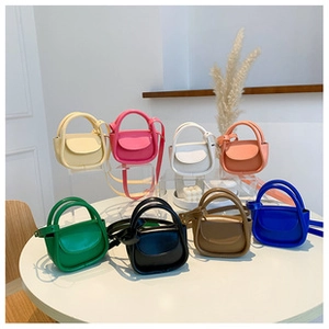 Collection of colorful mini bucket bags with curved handles and thin shoulder straps