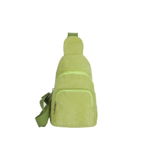 Light green corduroy crossbody bag with multiple zip pockets and adjustable strap