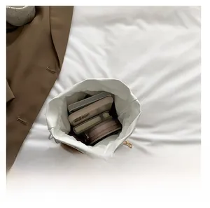 Interior view showing the large capacity of the plush cow print bucket bag for daily items