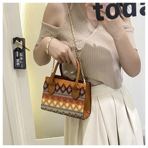 Ethnic style woven handbag with geometric patterns and brown leather straps for women