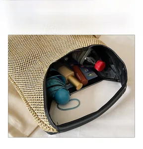 Internal display of the large woven straw tote bag showing ample space for daily items