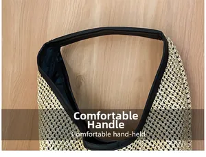 Close-up detail of durable black synthetic leather handle on woven straw beach tote bag