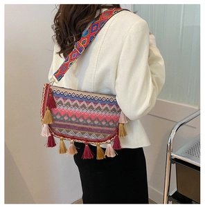 Detail of bohemian woven crossbody bag with colorful tassels and geometric jacquard strap
